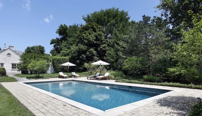 Swimming pool with deck chairs - Turnkey Pool Designers