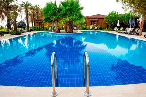 Huge pool with trees in the middle - Turnkey Pool Designers