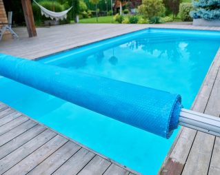 Outdoor swimming pool in the backyard, exterior private residence, lawn grass garden background