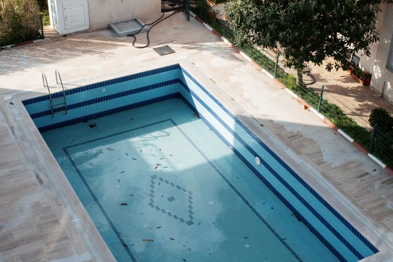 Tiled swimming pool showing surface wear over time, illustrating how pool materials age